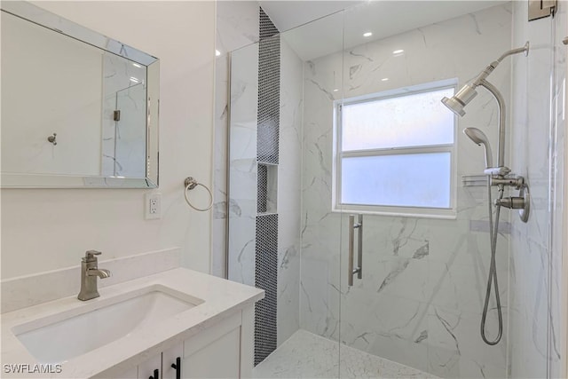 bathroom with a shower with door and vanity