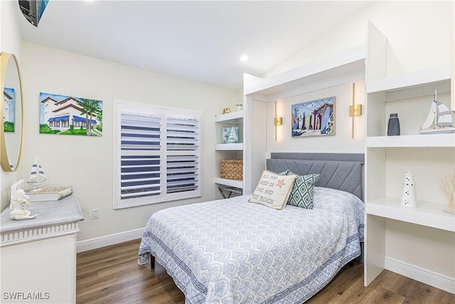 bedroom featuring vaulted ceiling and dark hardwood / wood-style flooring