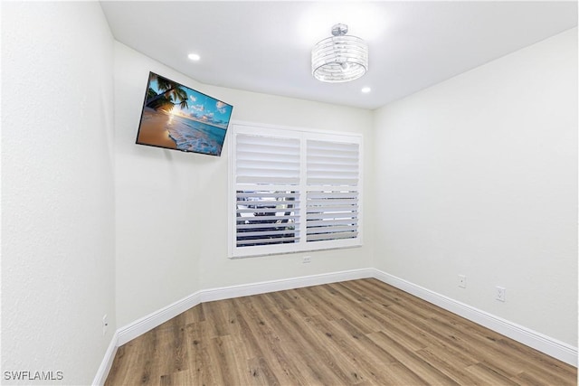 unfurnished room with hardwood / wood-style flooring