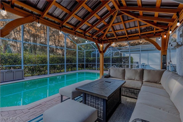 view of pool with an outdoor living space, a patio area, and a lanai