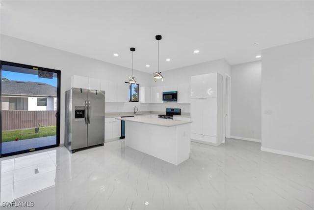 kitchen featuring white cabinetry, decorative light fixtures, a center island, appliances with stainless steel finishes, and a wealth of natural light