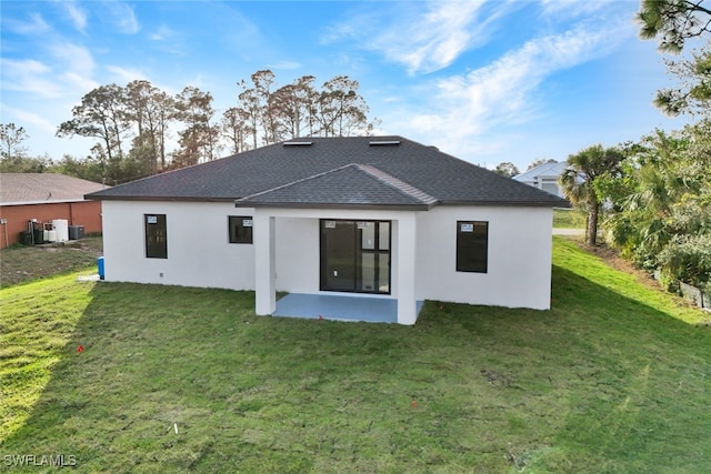 rear view of house with a yard and a patio area