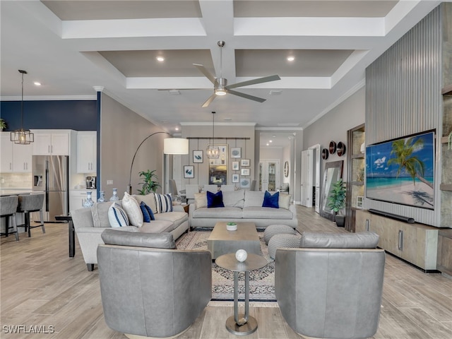 living room with ceiling fan with notable chandelier, ornamental molding, light hardwood / wood-style flooring, beam ceiling, and coffered ceiling