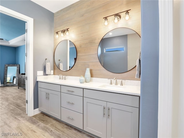 bathroom with vanity and wood walls