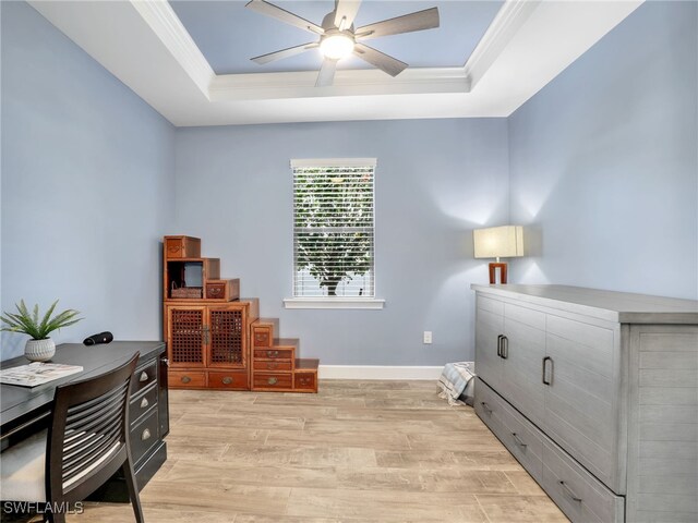 office featuring crown molding, a tray ceiling, and light hardwood / wood-style floors