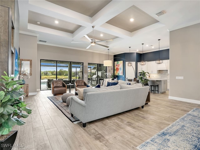 living room with ceiling fan, beam ceiling, coffered ceiling, and ornamental molding