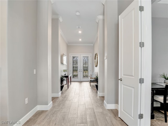 hallway with ornamental molding and french doors