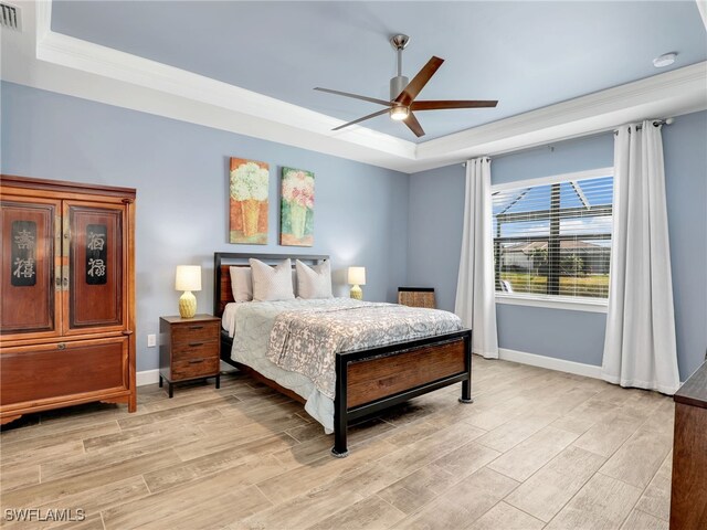 bedroom featuring ceiling fan, ornamental molding, and a raised ceiling