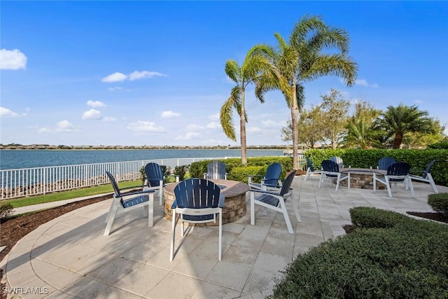 view of patio / terrace with a water view and an outdoor fire pit