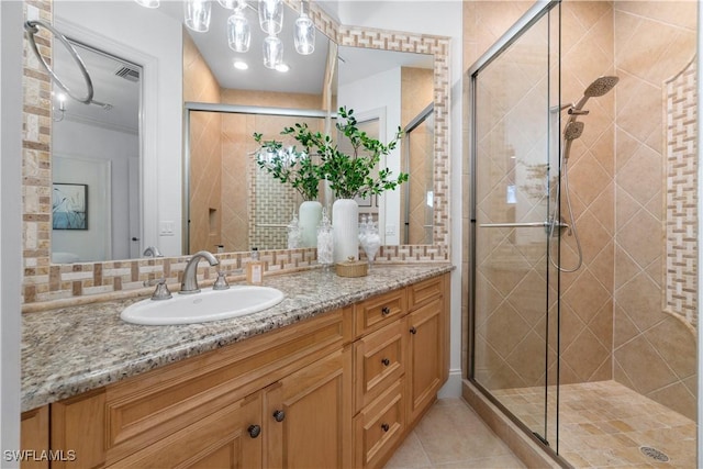 bathroom featuring walk in shower, vanity, and decorative backsplash