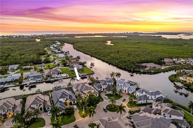 aerial view at dusk with a water view