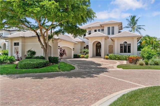 mediterranean / spanish-style home with a garage