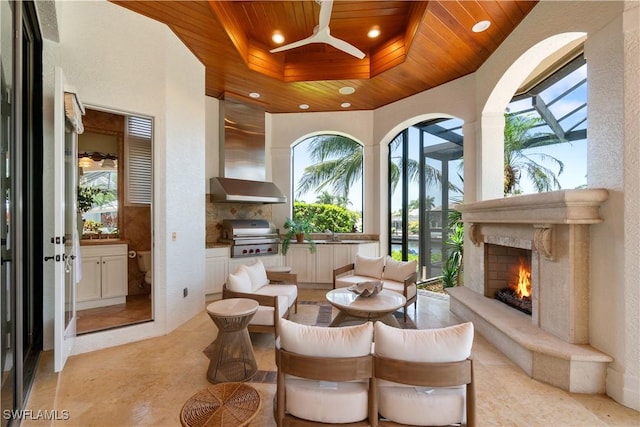 interior space with wood ceiling, a high end fireplace, and sink