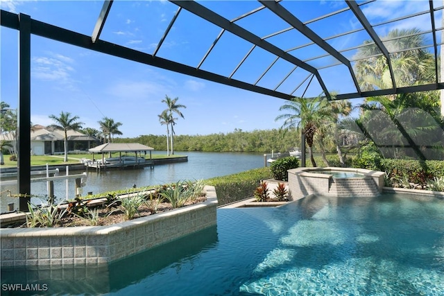 view of pool featuring a water view, glass enclosure, and an in ground hot tub