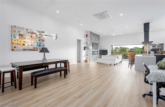 dining area featuring light wood-type flooring and ceiling fan