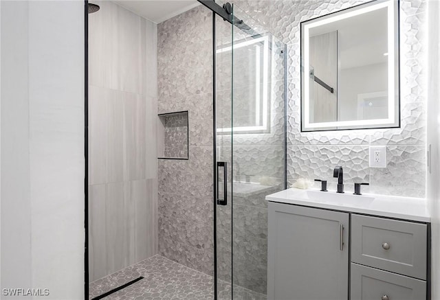 bathroom with an enclosed shower and vanity