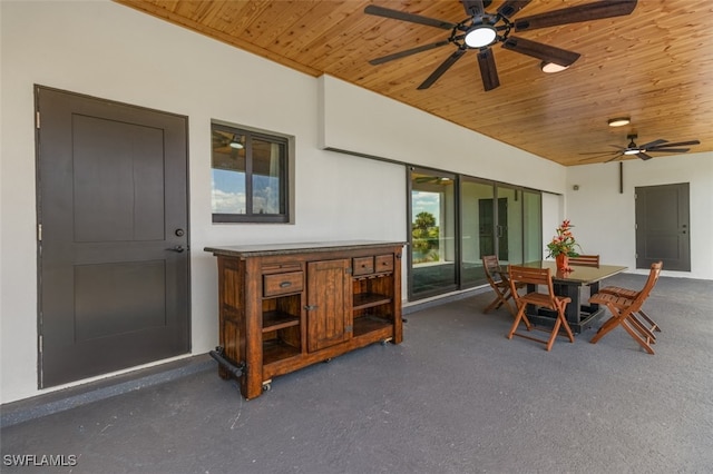 sunroom / solarium with wooden ceiling and ceiling fan