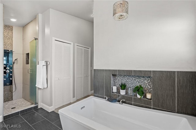 bathroom with tile patterned floors and separate shower and tub