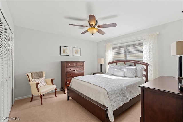 carpeted bedroom with a closet and ceiling fan