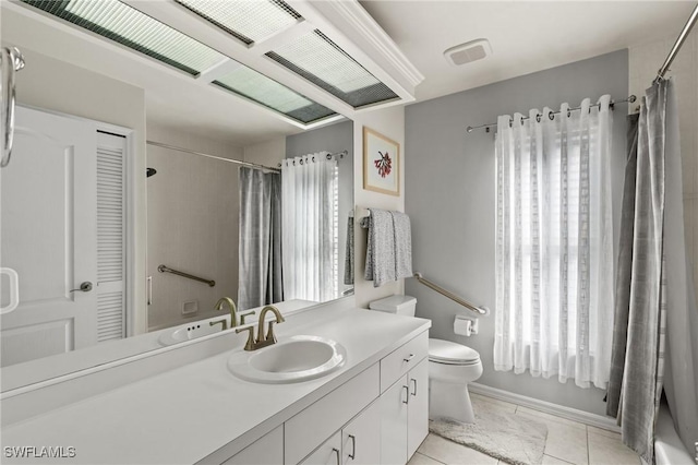 full bathroom with shower / bath combo, tile patterned floors, vanity, and toilet