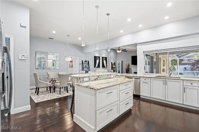 kitchen featuring ceiling fan, stainless steel appliances, pendant lighting, and white cabinets