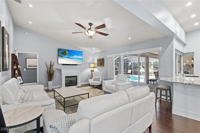 living room with lofted ceiling, ceiling fan, dark hardwood / wood-style flooring, and sink