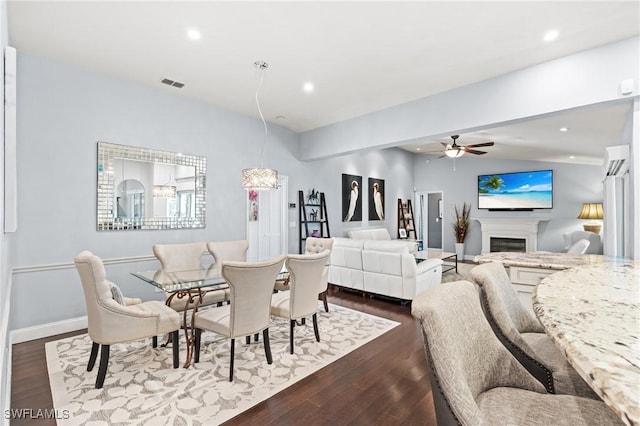 dining space with ceiling fan, dark wood-type flooring, and lofted ceiling