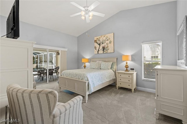 carpeted bedroom with ceiling fan and high vaulted ceiling