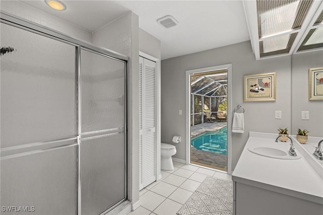 bathroom with toilet, vanity, an enclosed shower, and tile patterned flooring