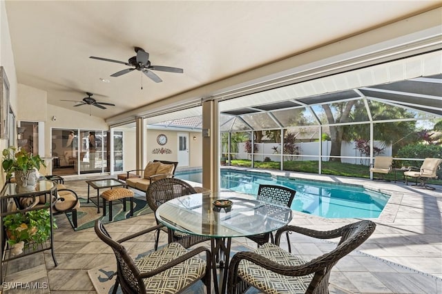 view of swimming pool featuring ceiling fan, a lanai, and a patio