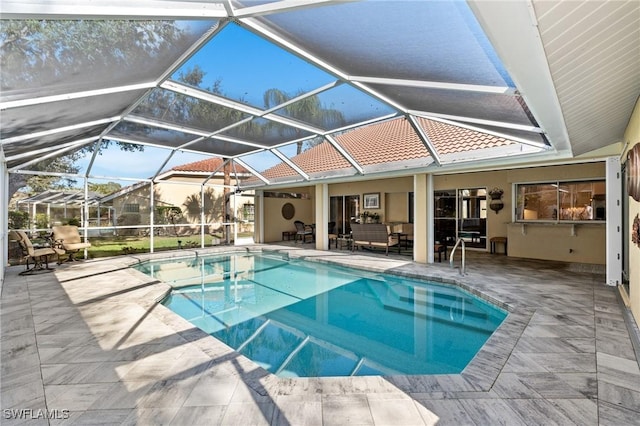 view of swimming pool featuring a lanai and a patio