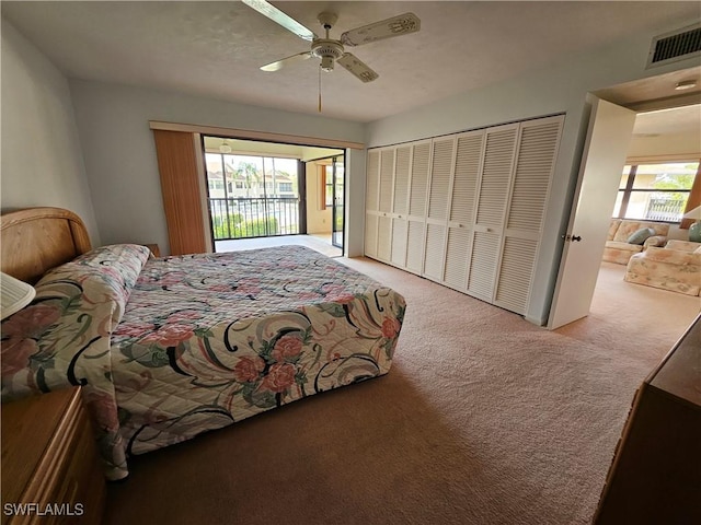 bedroom with ceiling fan, light carpet, and a closet