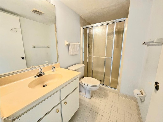 bathroom featuring toilet, tile patterned floors, walk in shower, a textured ceiling, and vanity