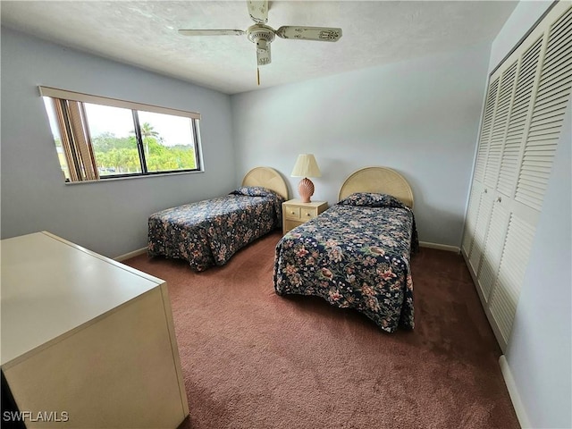 bedroom with ceiling fan, a closet, and dark colored carpet