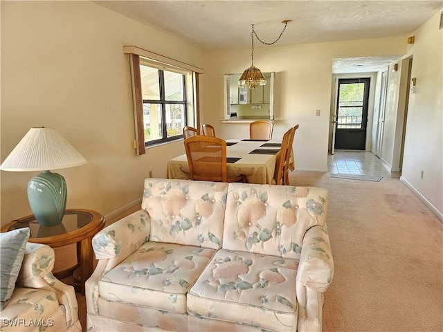 living room featuring light carpet and a chandelier