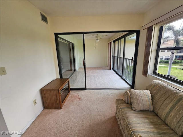 sunroom featuring ceiling fan