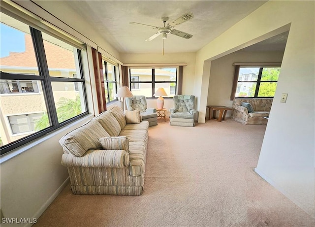 sunroom / solarium featuring ceiling fan and a wealth of natural light