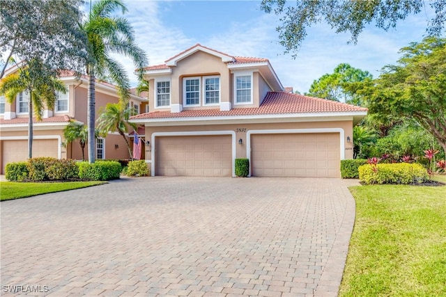 mediterranean / spanish house with a front lawn and a garage