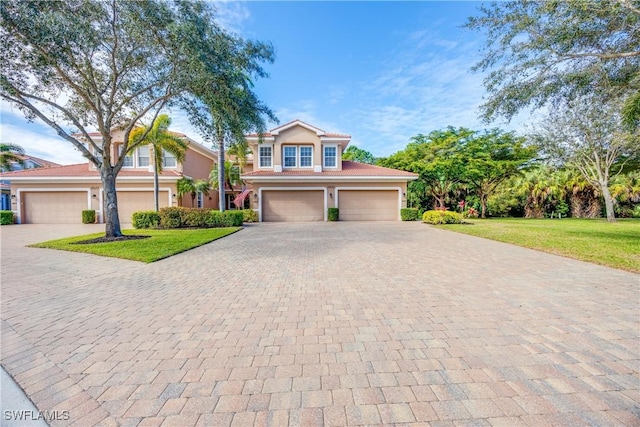 view of front of house with a garage and a front yard