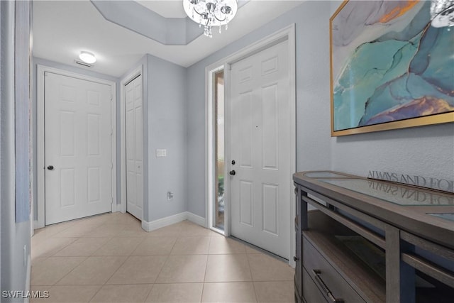 entrance foyer featuring a chandelier and light tile patterned flooring