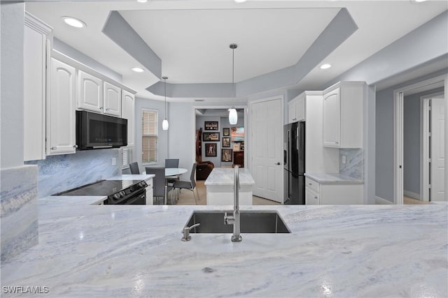 kitchen with white cabinetry, hanging light fixtures, stainless steel fridge with ice dispenser, a raised ceiling, and electric range