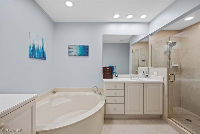 bathroom featuring plus walk in shower, tile patterned floors, and vanity