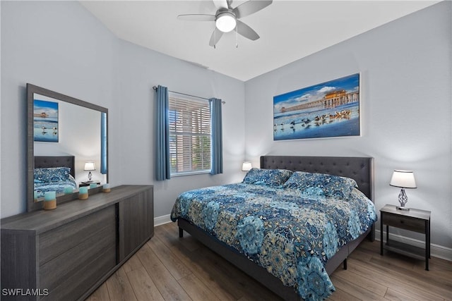 bedroom with ceiling fan and hardwood / wood-style flooring