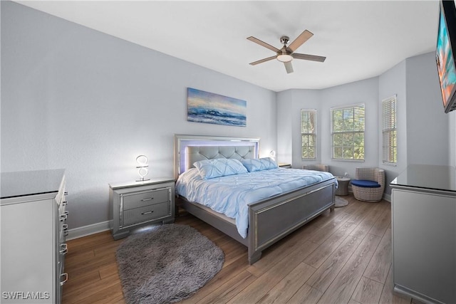 bedroom featuring ceiling fan and dark hardwood / wood-style flooring