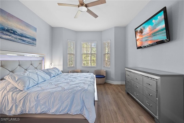 bedroom with ceiling fan and dark hardwood / wood-style floors