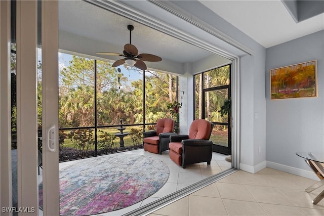 sunroom featuring ceiling fan and a wealth of natural light