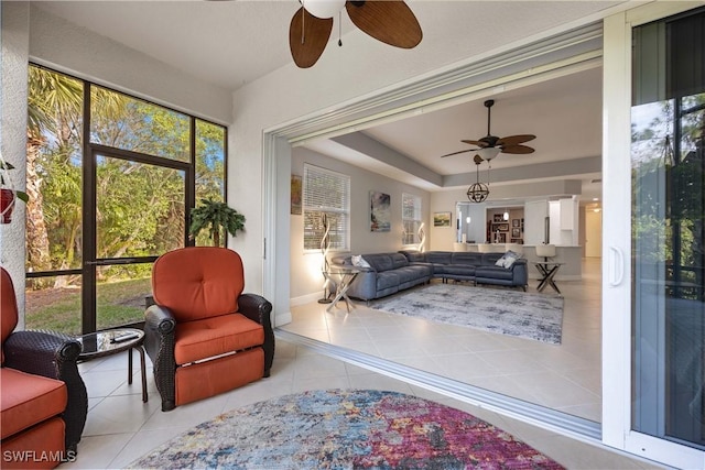 sunroom featuring ceiling fan and a tray ceiling