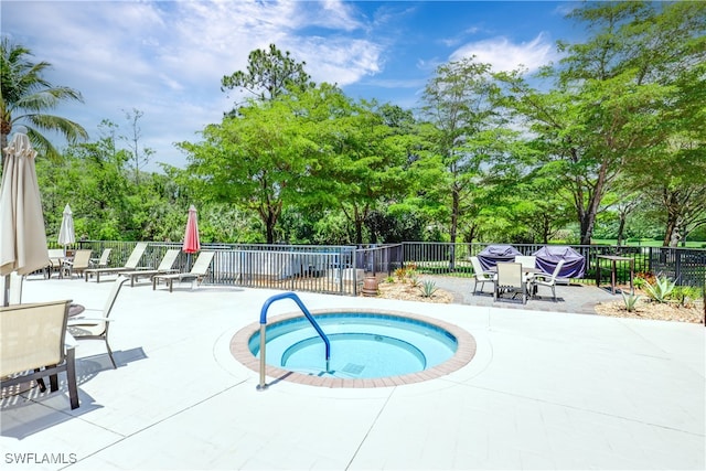 view of pool with a patio and a community hot tub