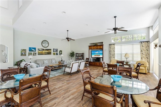 dining area with light wood-type flooring and ceiling fan