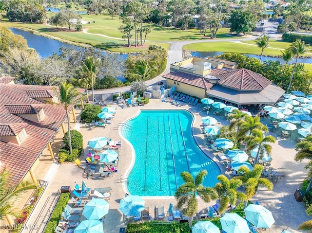 view of swimming pool featuring a patio area and a water view